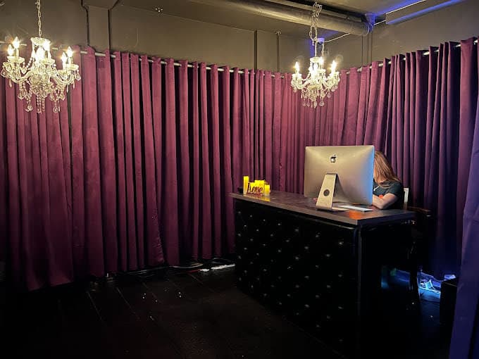 Reception desk with crystal chandeliers and velvet curtains