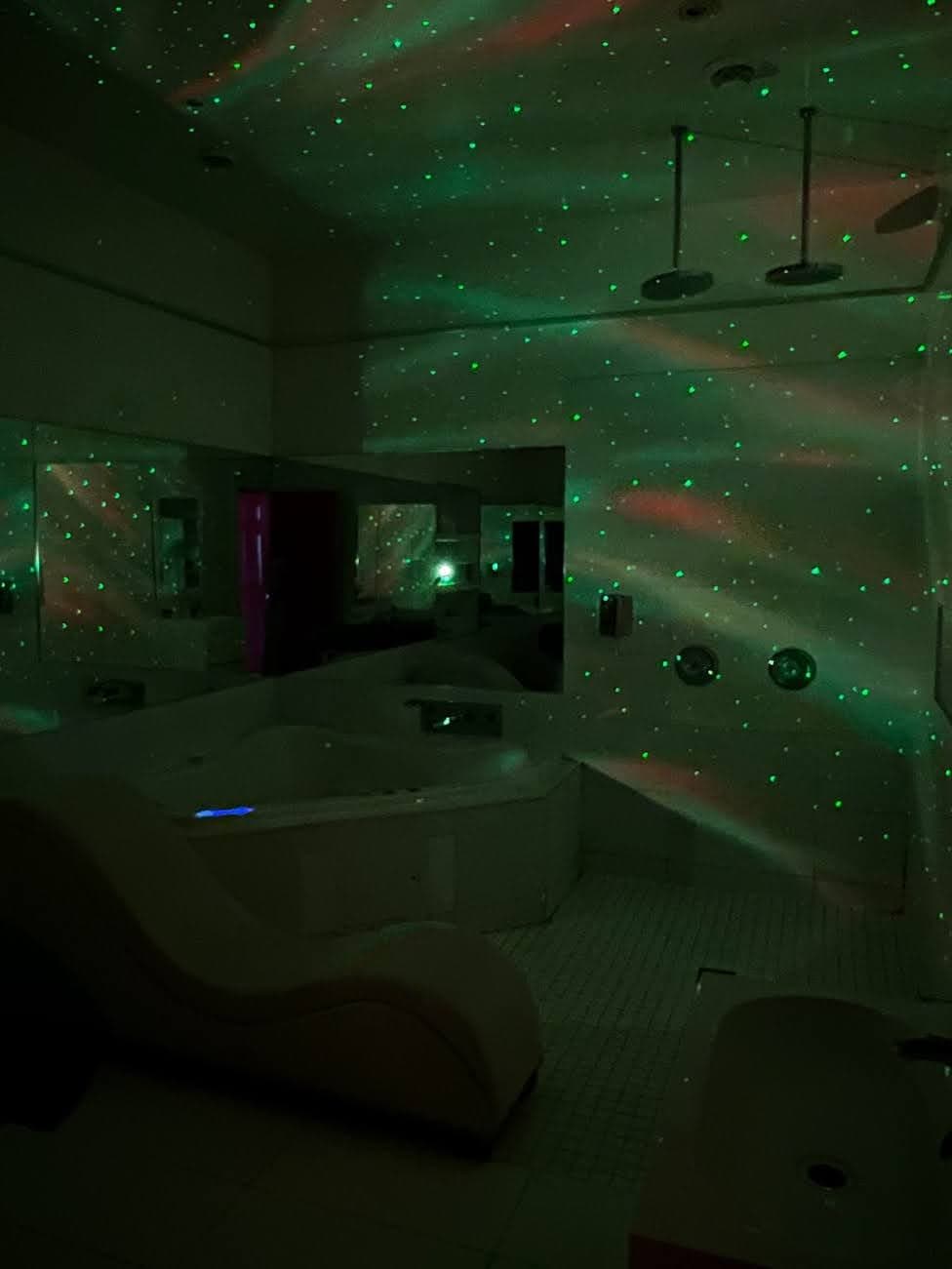 Starlight-projected jacuzzi suite with green aurora lighting